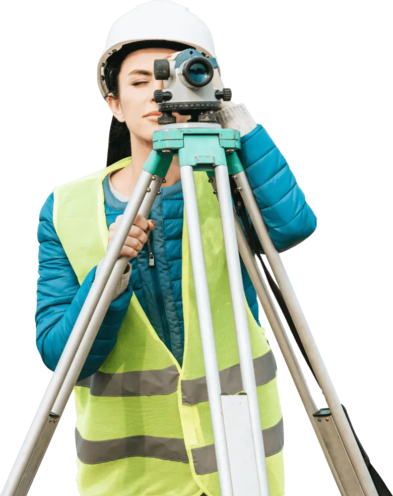 Surveyor using total station for land measurement